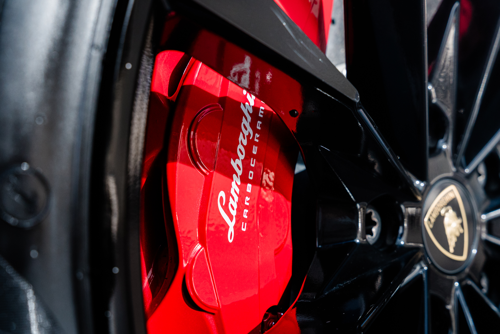 Close-up of a polished Lamborghini carbon-ceramic brake caliper
